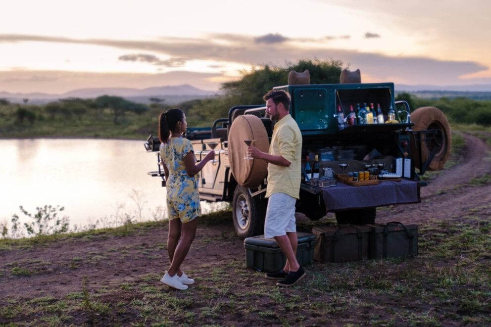 Man and woman on Game drive in Kruger National Park South Africa | Photo: fokkebok via Getty