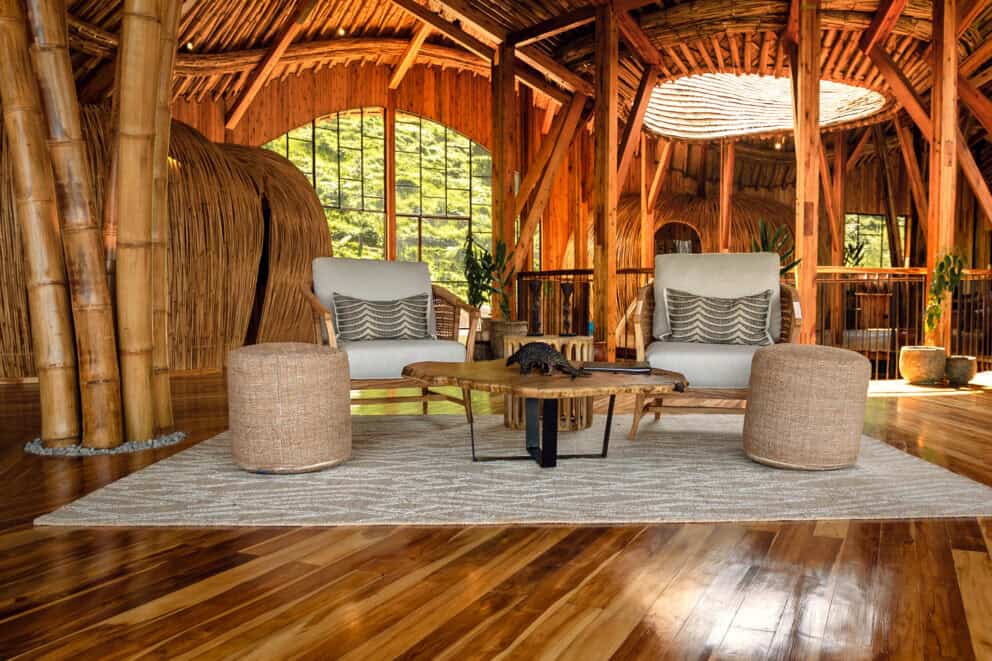 View of the lounge area, featuring plush cushioned armchairs and ottomans at Erebero Hills, Uganda.