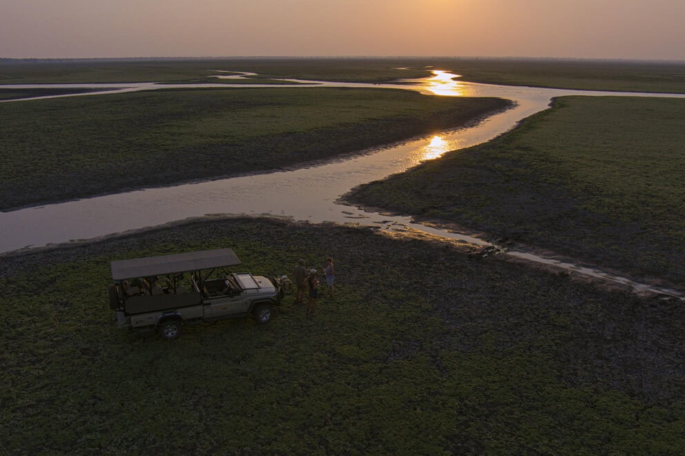 Travellers having sundowners in Gorongosa National Park at Muzimu Lodge, Mozambique.