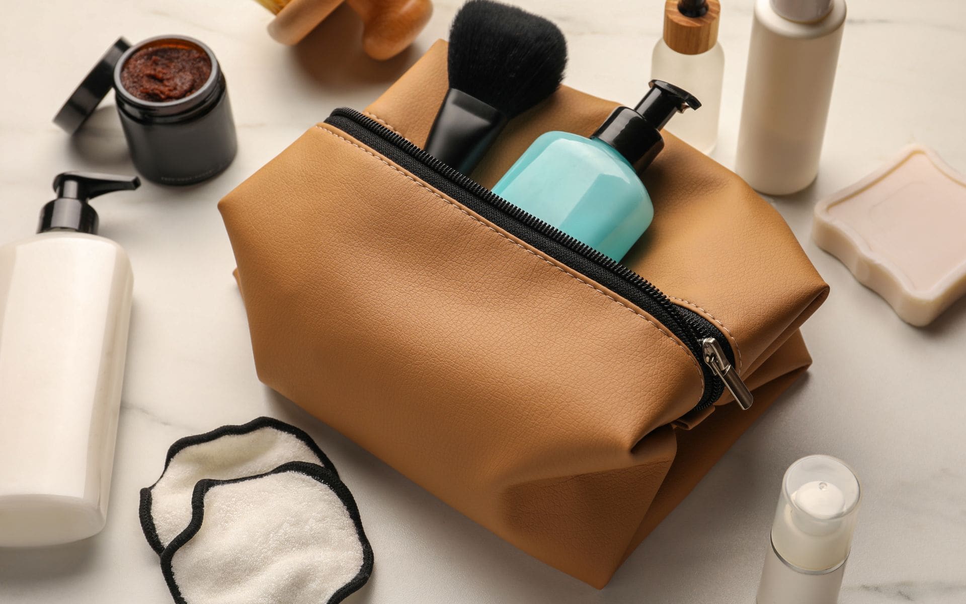 view of a brown toiletry bag filled with toiletries