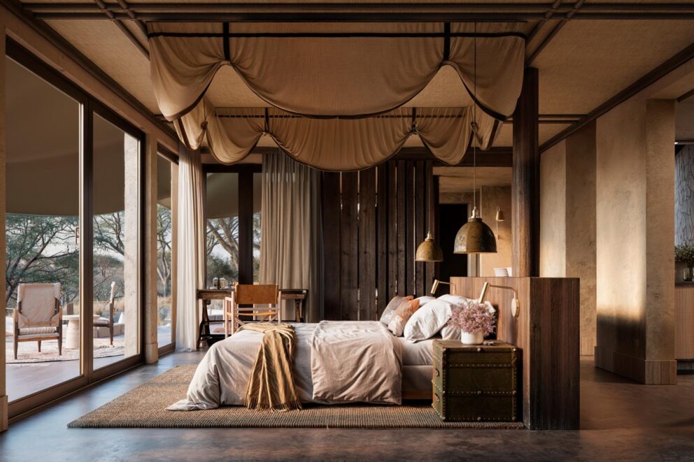 View of the luxury bedroom with earth tone decor at Sandringham N'weti Camp, South Africa.