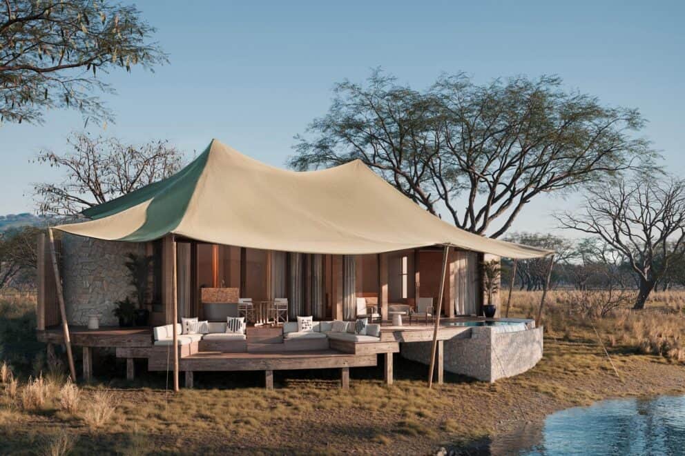 Exterior view of the tented suite, featuring a private deck and plunge pool overlooking the Timbavati River's dam at Sandringham N'weti Camp, South Africa.