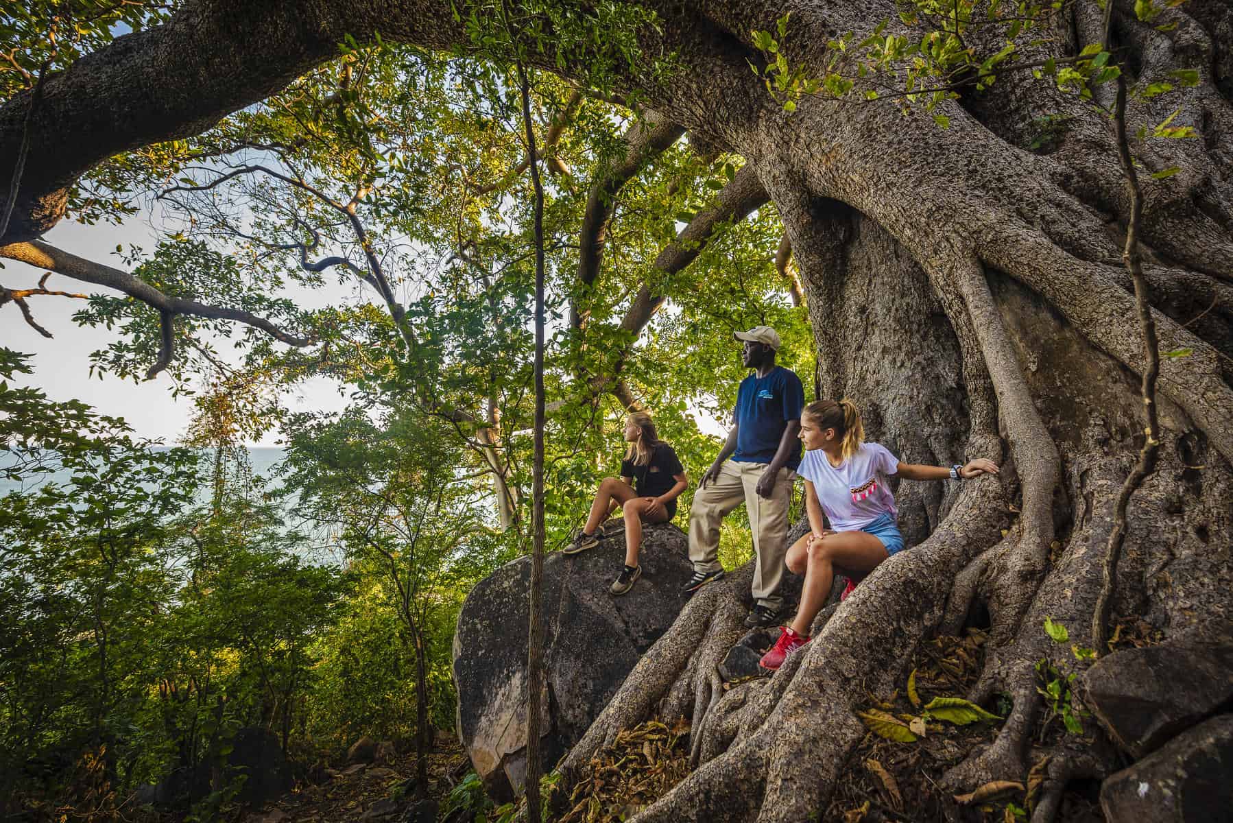 A guide showing guests the view of Lake Malawi from the hills