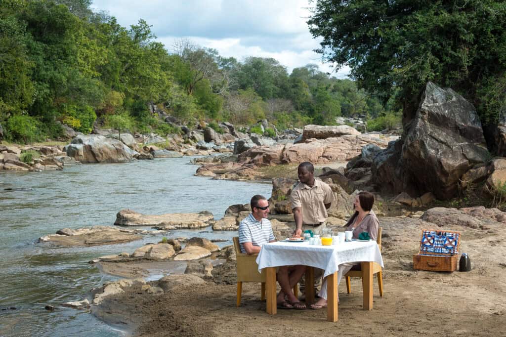 Dining next to a river in Majete Wildlife Reserve in Malawi