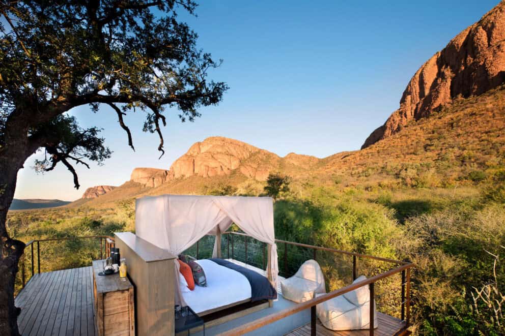 An outdoor bed under a canopy overlooking the Marakele National Park at Marataba Mountain Lodge, South Africa. 