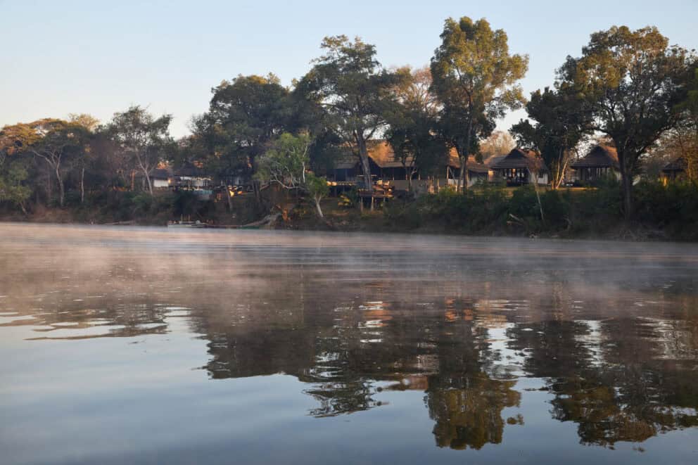 View of Lolelunga Lodge from the Lunga River at Lolelunga Private Reserve, Zambia.