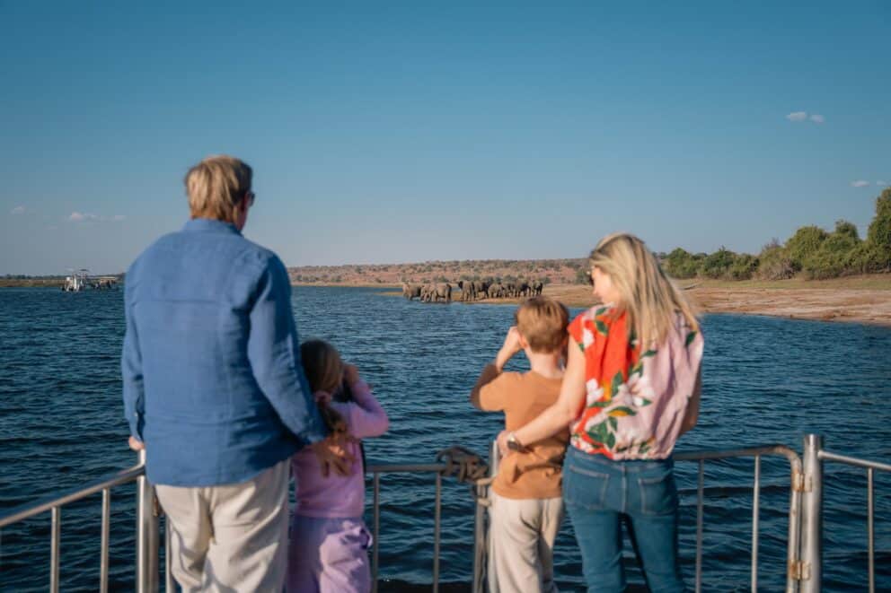 A family admiring the Chobe River at Chobe Safari Lodge, Botswana.