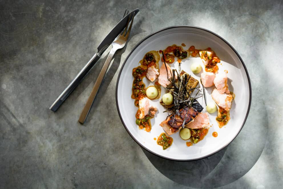 View of a plated meal with cutlery on the side at Singita Lebombo Lodge, South Africa.