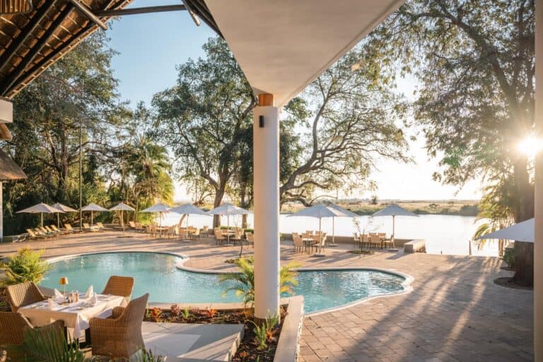 View of the pool area with a view of the Chobe River at Chobe Safari Lodge, Botswana.
