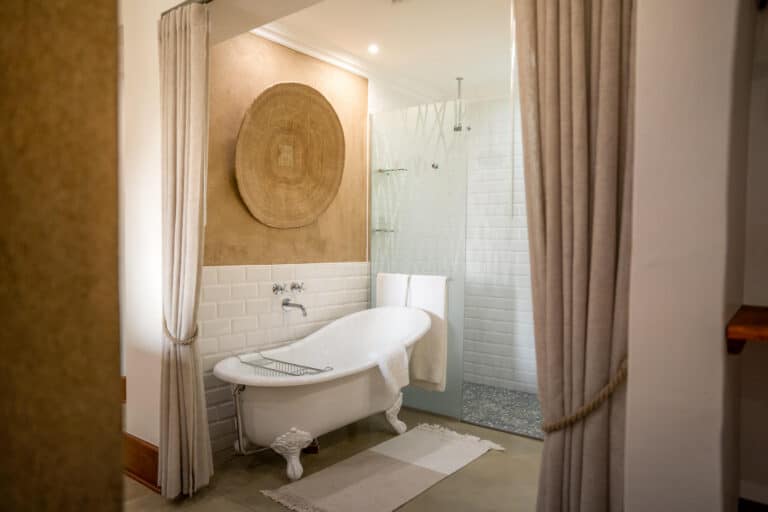 View of the luxury bathroom, featuring a freestanding slipper bath at Chobe Safari Lodge, Botswana.