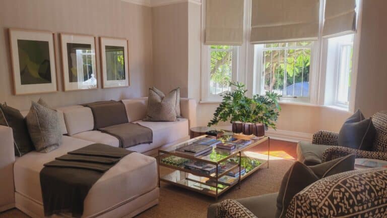 View of the lounge, featuring elegant seating with a large window at Blackheath Lodge, South Africa.