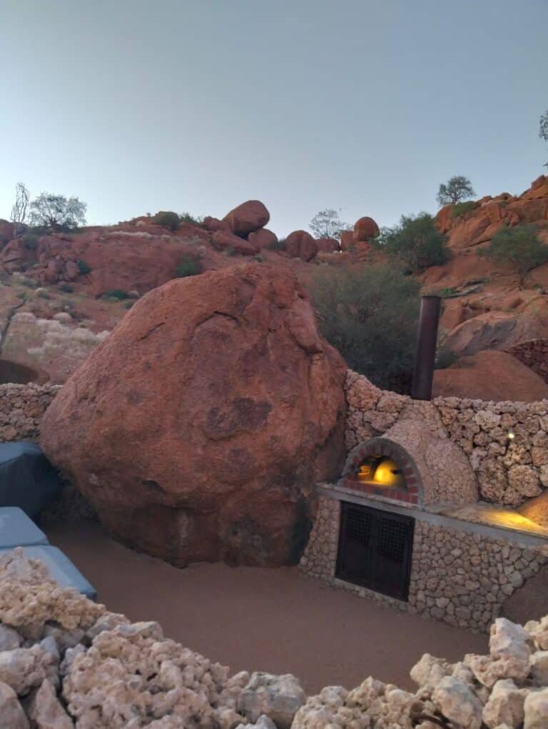 View of a pizza oven next to a boulder at Onduli Ridge, Damaraland, Namibia.