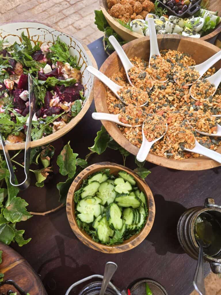 A vibrant array of colourful gourmet dishes featuring fresh garden produce at Wolwedans Desert Garden, Namibia.