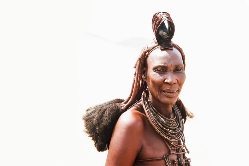 A close up of a Himba woman covered in the red ochre pigment near Wilderness Serra Cafema, Namibia.