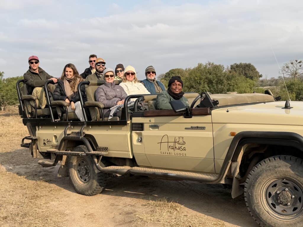 Guests on a game drive in a safari vehicle near Arathusa Safari Lodge in Sabi Sand, South Africa.